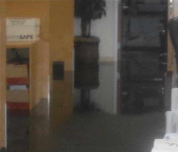 Photo shows a flooded office with standing water
