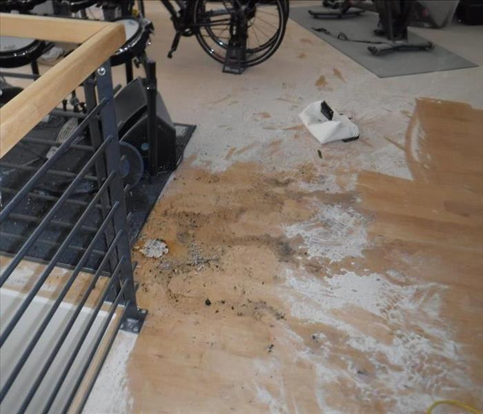 Image shows fire extinguisher debris spread throughout a lofts flooring