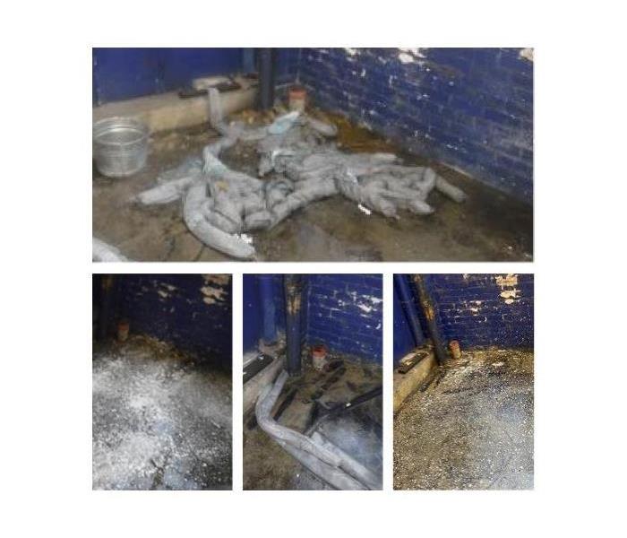 Photo shows a warehouse with sewage being cleaned from the flooring